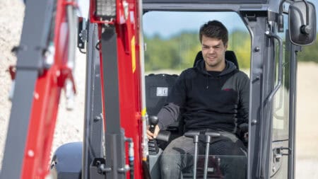 Veilig werken met compactieve graafmachine en professionele machinist op bouwlocatie.