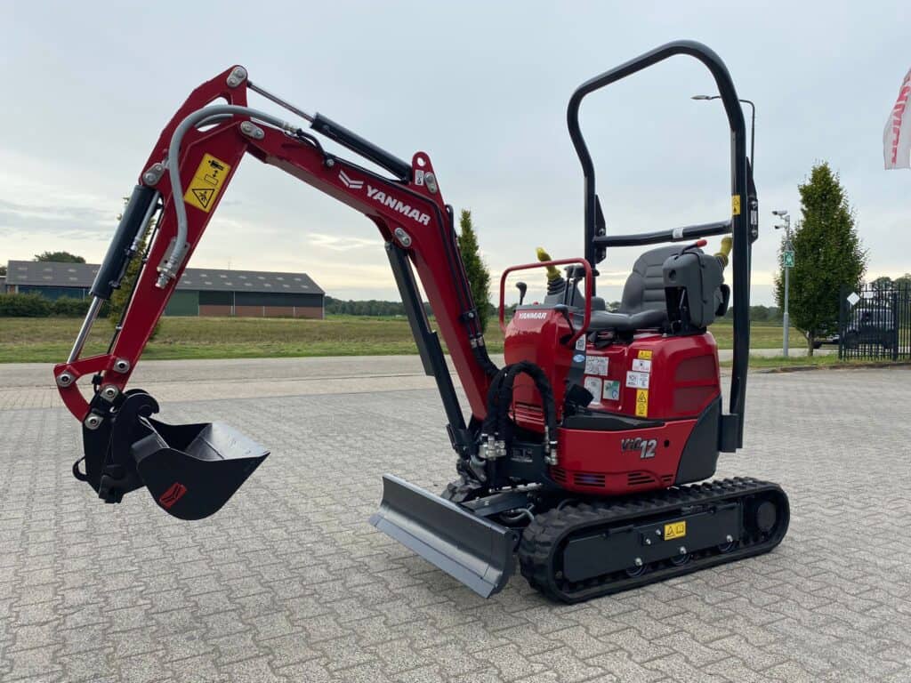 Kleine graafmachine Yanmar op betonnen vloer voor grondwerk en tuinprojecten.